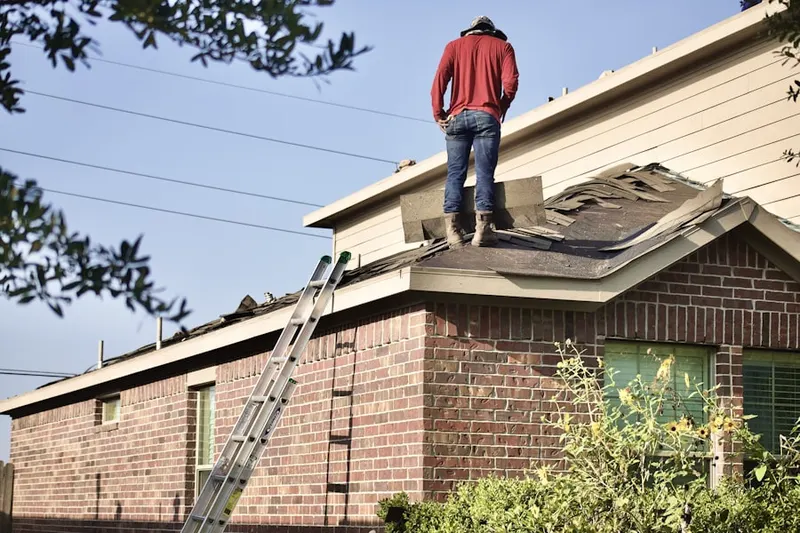 Professional roofer working on a residential roof in Frost Farms